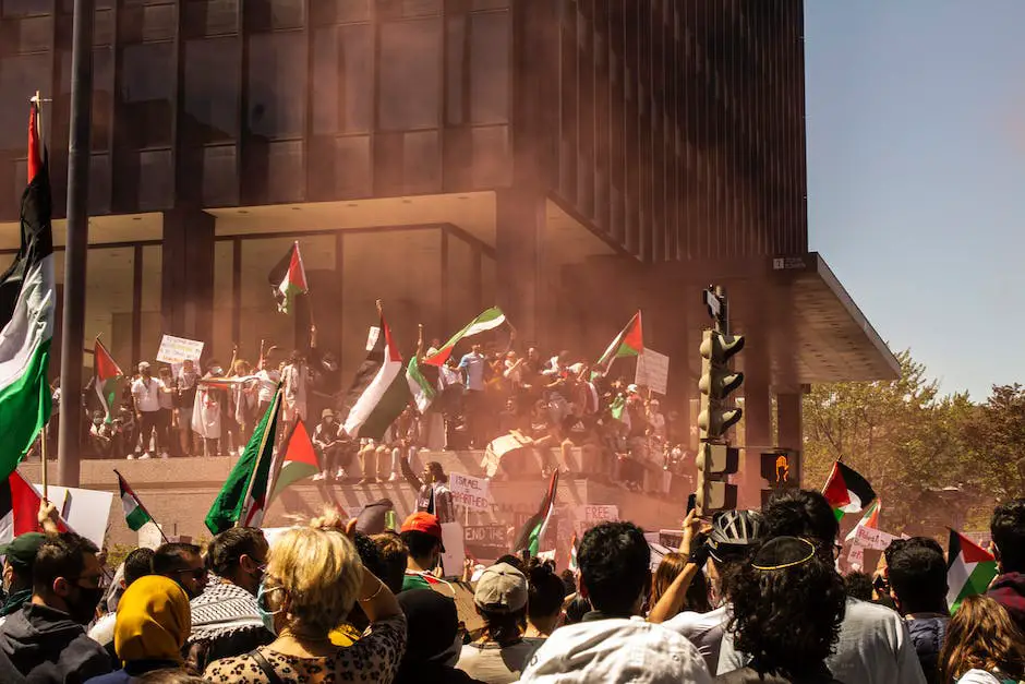 A group of protesters holding Palestinian flags and signs advocating for Arab support to the Palestinian cause.