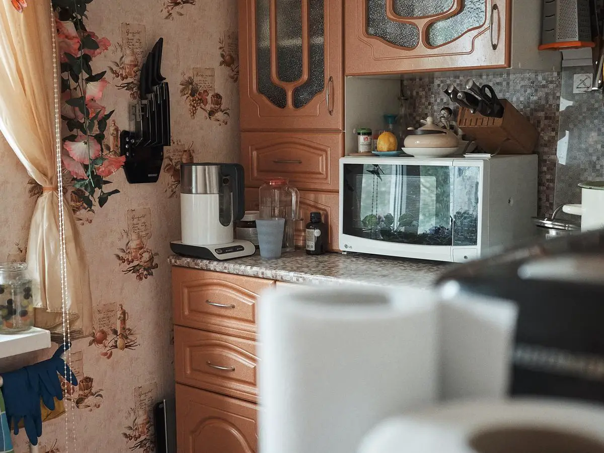 Microwave oven being used safely in a kitchen