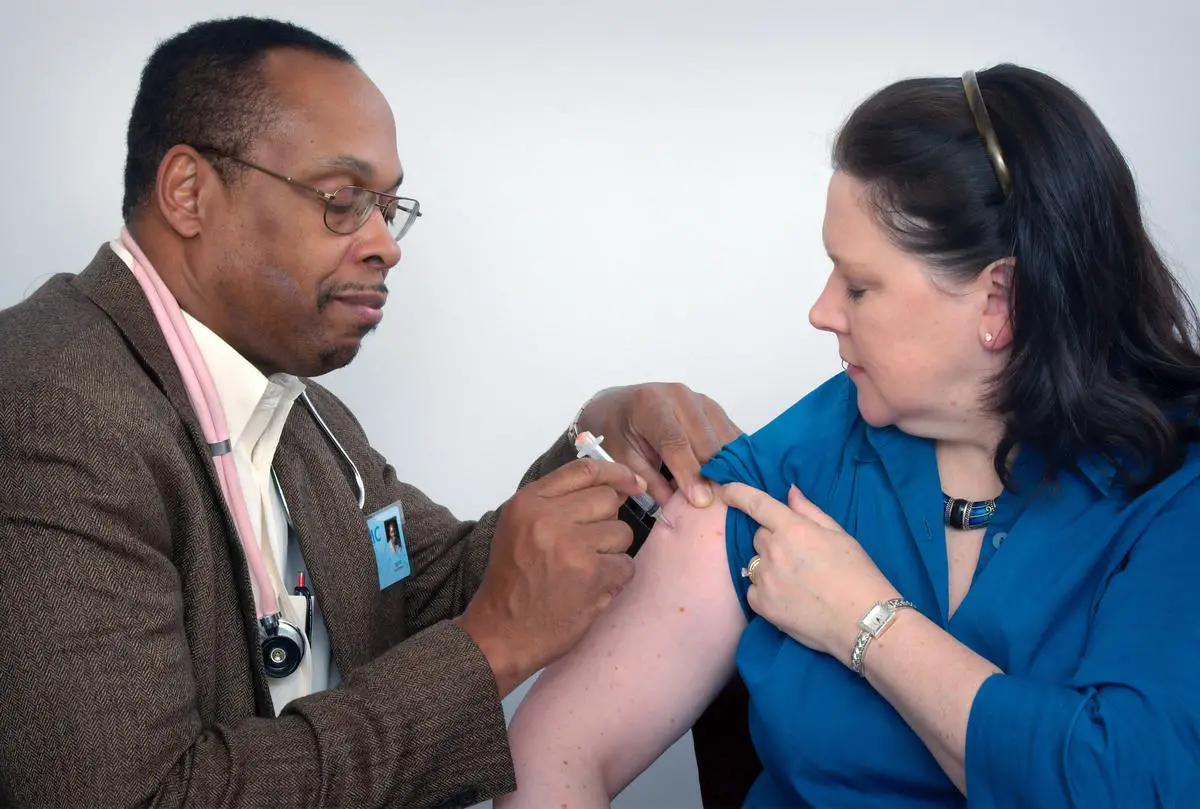 An image depicting a healthcare professional administering a Vitamin K injection to an infant